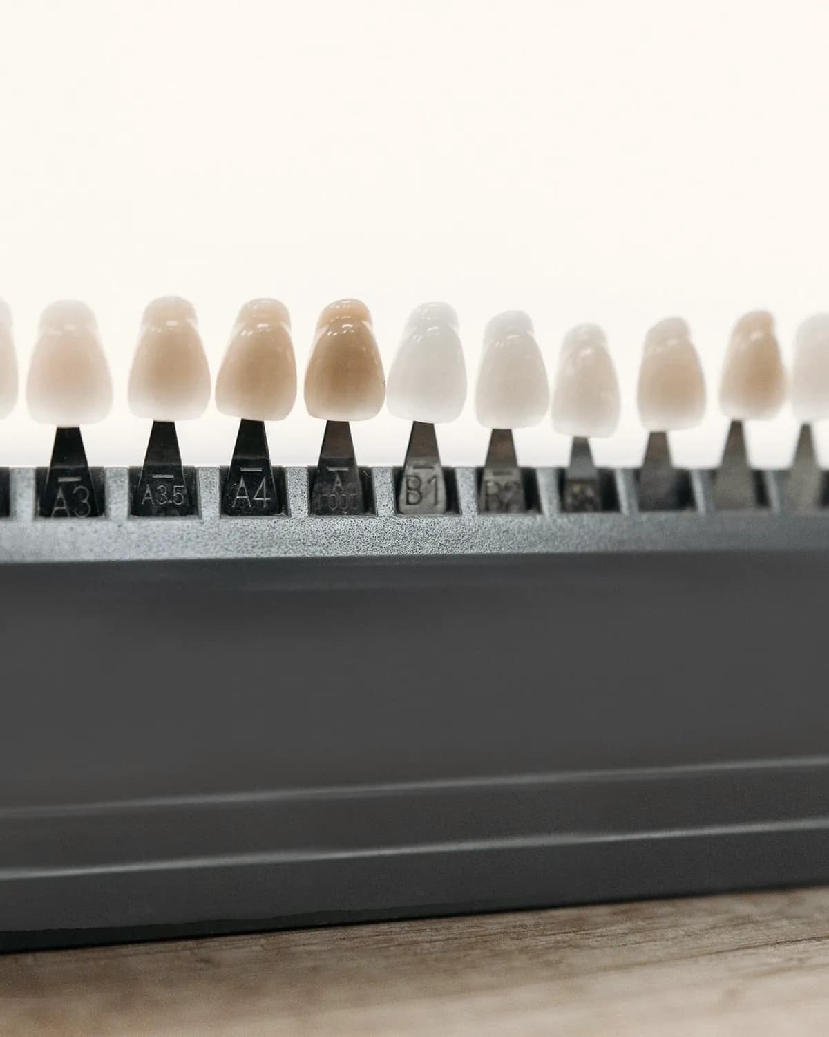 A porcelain shade guide showing a range of tooth colours